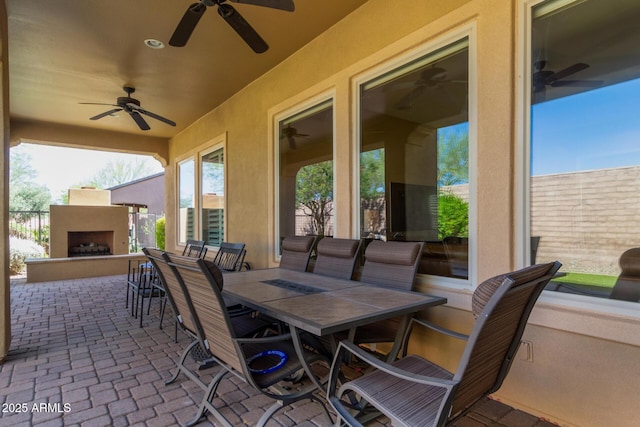 29159 N 128th Ln, Peoria, AZ 85383 - view of patio featuring an outdoor fireplace, ceiling fan, outdoor dining area, and fence