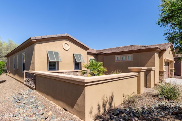 29159 N 128th Ln, Peoria, AZ 85383 - back of property featuring stucco siding, stone siding, fence, an attached garage, and concrete driveway