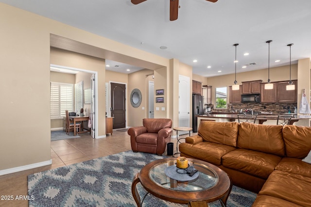 29159 N 128th Ln, Peoria, AZ 85383 - living room with a ceiling fan, baseboards, light tile patterned floors, and recessed lighting