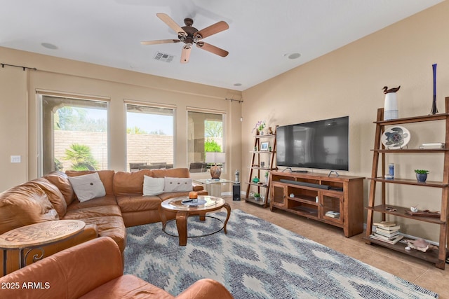 29159 N 128th Ln, Peoria, AZ 85383 - tiled living room with healthy amount of natural light and ceiling fan