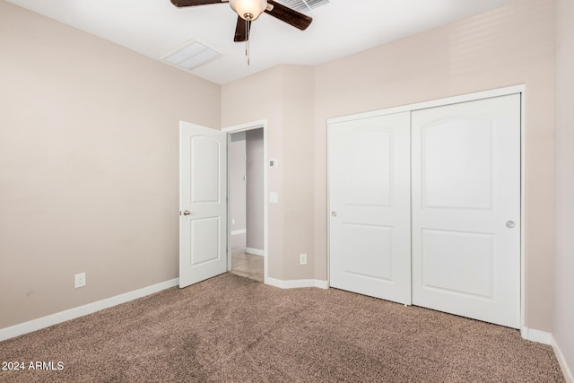 unfurnished bedroom with a closet, carpet, and ceiling fan