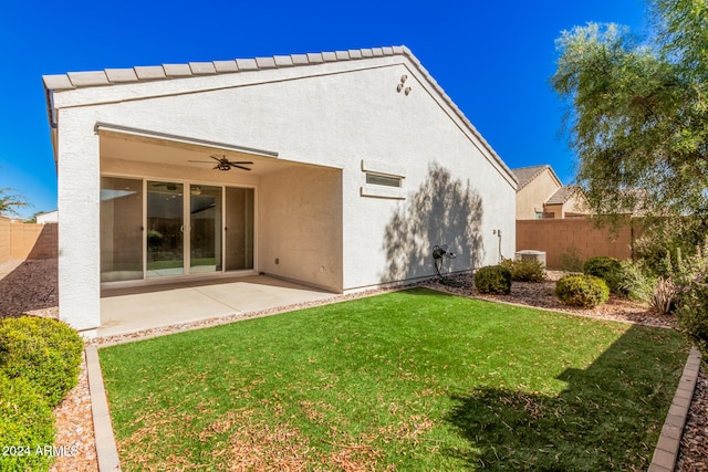 back of house featuring a patio area, a lawn, and ceiling fan