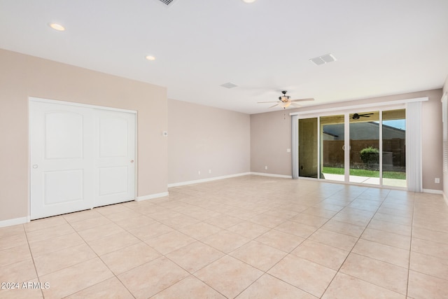 unfurnished room featuring light tile patterned floors and ceiling fan