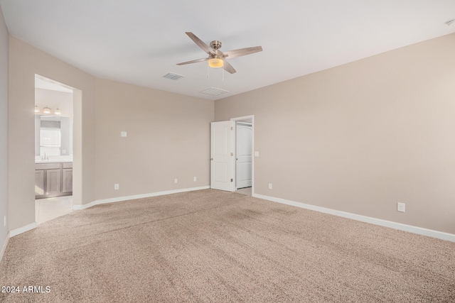 unfurnished room featuring ceiling fan and light colored carpet