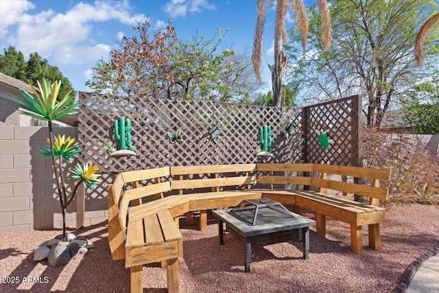 view of patio featuring a fire pit and fence