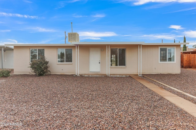 rear view of house with fence and central air condition unit