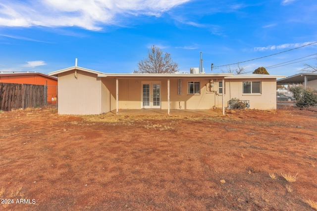 back of property featuring fence, a patio, and french doors