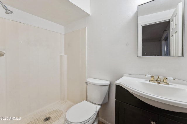 bathroom featuring vanity, a shower, and toilet