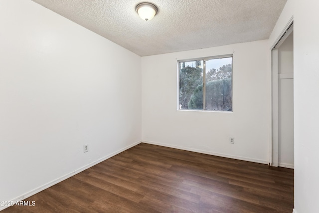 unfurnished bedroom with a closet, dark hardwood / wood-style floors, and a textured ceiling