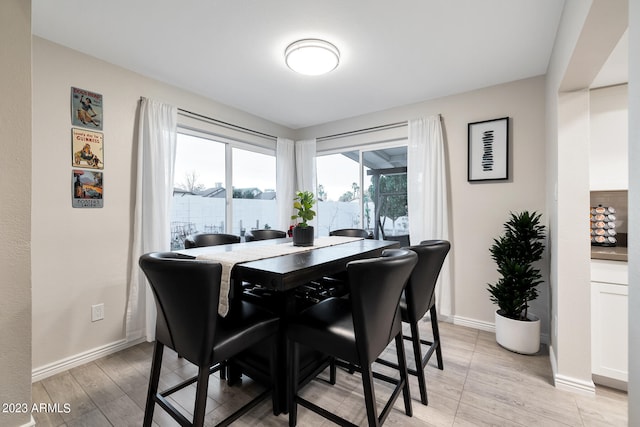 dining space with light hardwood / wood-style flooring