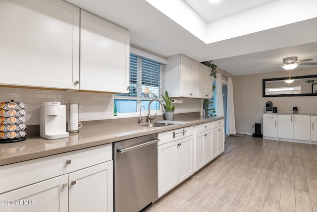 kitchen featuring stainless steel dishwasher, ceiling fan, white cabinets, backsplash, and sink