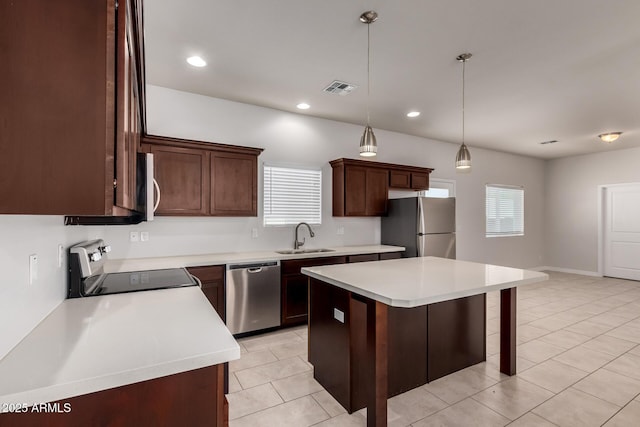 2000 N 36th St Unit 10, Phoenix, AZ 85008 - kitchen with appliances with stainless steel finishes, a kitchen breakfast bar, light tile patterned floors, light countertops, and a center island