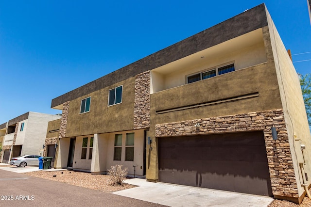 2000 N 36th St Unit 10, Phoenix, AZ 85008 - view of front of house featuring stone siding, an attached garage, and stucco siding