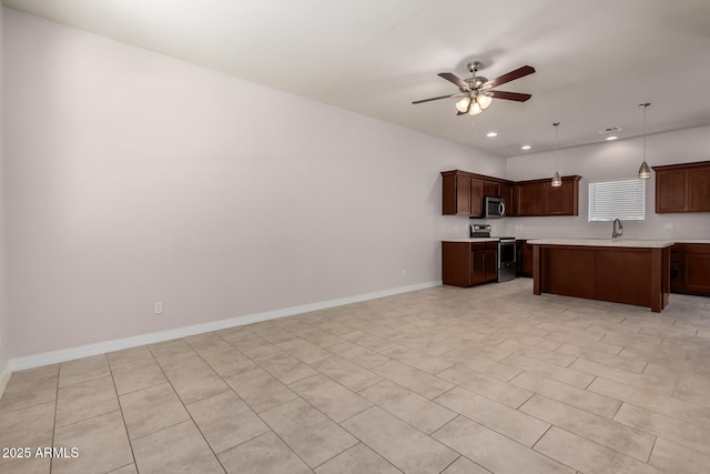 2000 N 36th St Unit 10, Phoenix, AZ 85008 - kitchen with stainless steel appliances, light countertops, open floor plan, ceiling fan, and recessed lighting