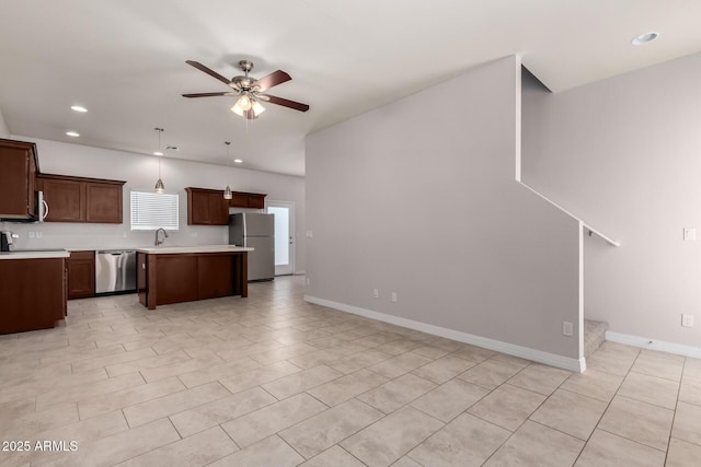 2000 N 36th St Unit 10, Phoenix, AZ 85008 - kitchen featuring stainless steel appliances, light countertops, a ceiling fan, open floor plan, and a kitchen island