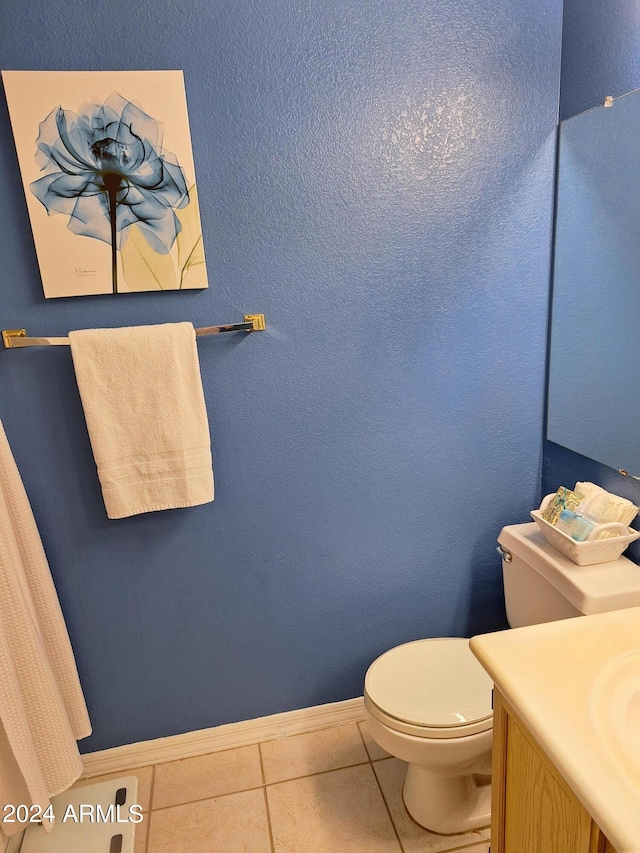 bathroom featuring tile patterned floors, vanity, and toilet