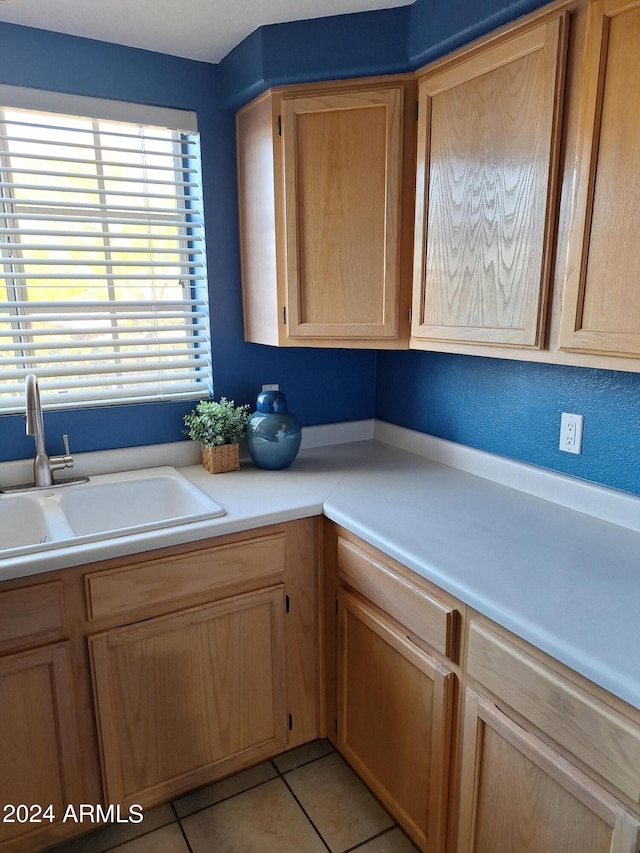 kitchen featuring sink and light tile patterned floors