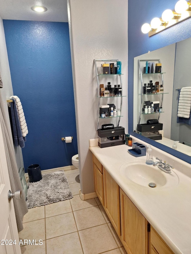 bathroom featuring vanity, toilet, and tile patterned floors