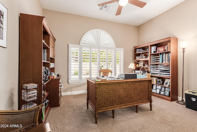 carpeted office space with ceiling fan