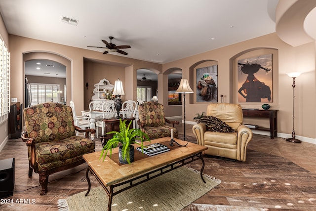 living room featuring wood-type flooring and ceiling fan