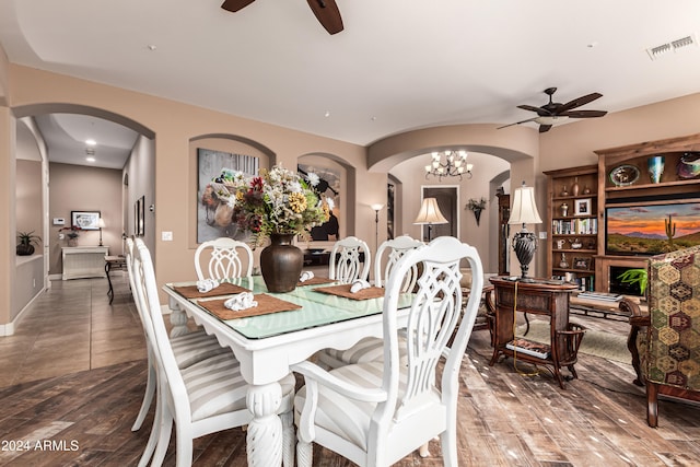 dining room featuring hardwood / wood-style flooring and ceiling fan with notable chandelier