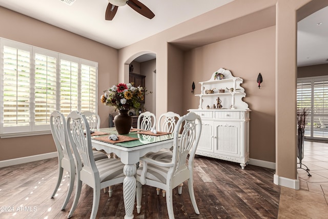 dining space featuring dark wood-type flooring, a healthy amount of sunlight, and ceiling fan