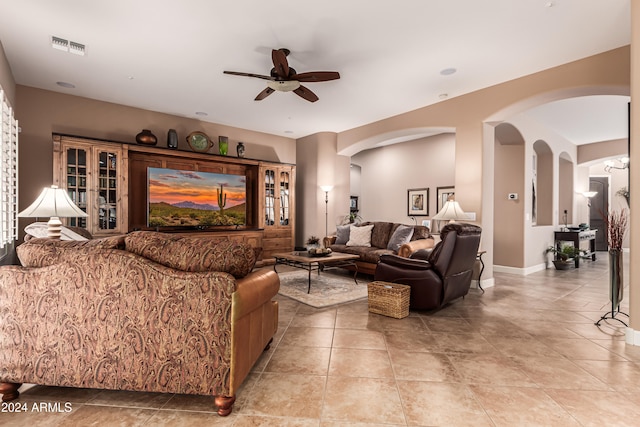 living room featuring light tile patterned floors and ceiling fan