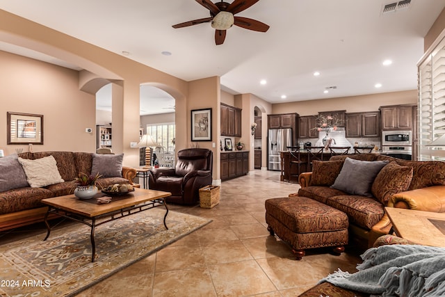 tiled living room with ceiling fan