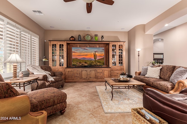 living room featuring ceiling fan and light tile patterned floors