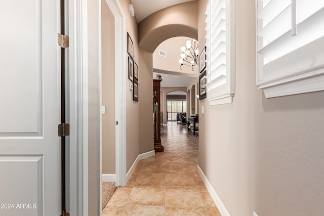 hall featuring an inviting chandelier