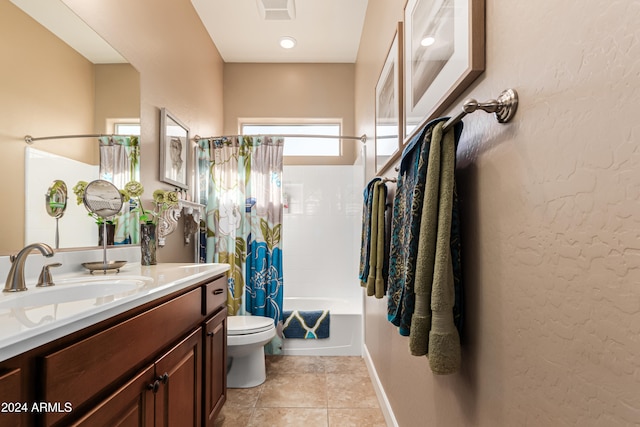 full bathroom featuring tile patterned flooring, vanity, shower / bath combo with shower curtain, and toilet