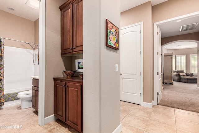 corridor featuring light tile patterned floors