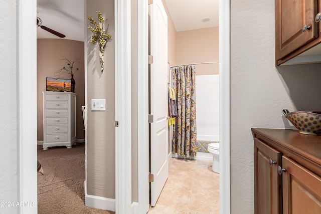 hallway featuring light colored carpet