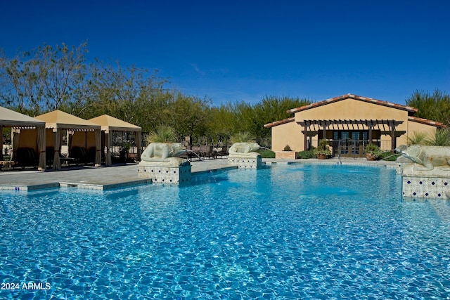 view of swimming pool with a patio and a gazebo