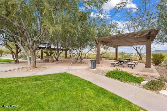 surrounding community with a pergola, a lawn, and a patio