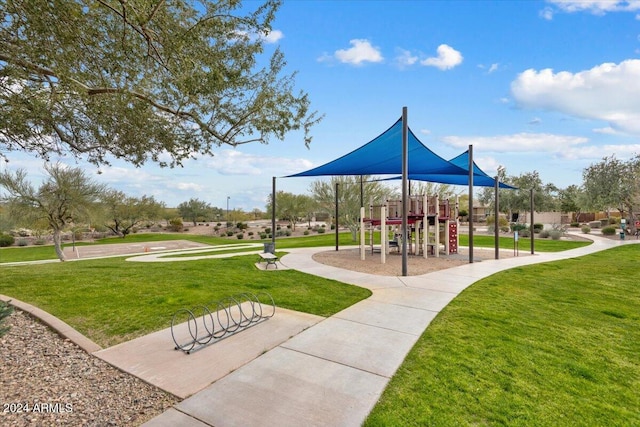 view of home's community with a lawn and a playground