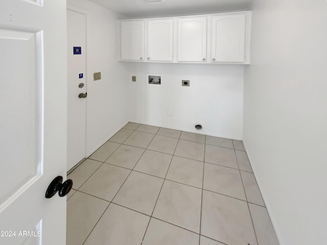 laundry area featuring cabinets, hookup for a washing machine, gas dryer hookup, electric dryer hookup, and light tile patterned floors