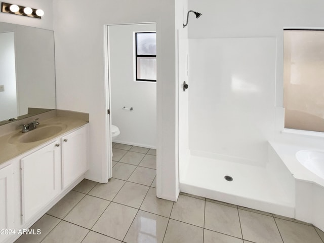 bathroom featuring tile patterned floors, vanity, and toilet