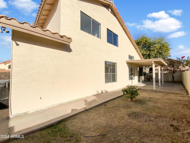 view of property exterior with a patio area