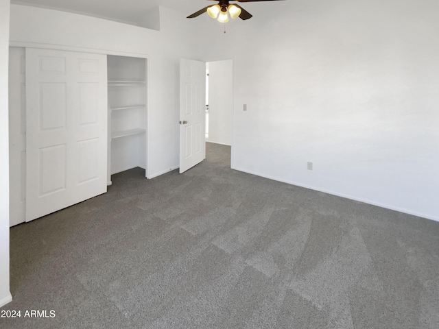 unfurnished bedroom featuring ceiling fan, a closet, and dark carpet