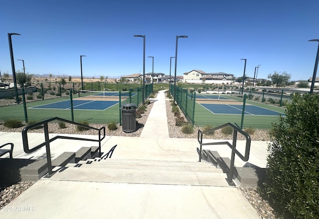 view of tennis court featuring fence
