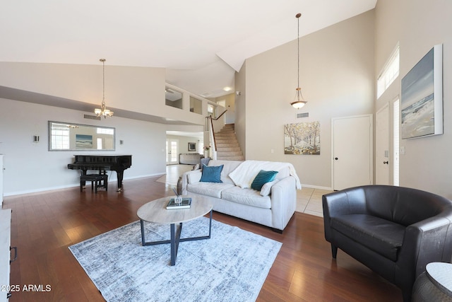 living room featuring dark wood-type flooring and high vaulted ceiling