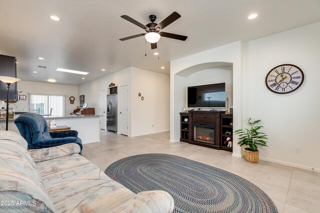 293 S Meadowood Ln, Sierra Vista, AZ 85635 - living room with light tile patterned floors, recessed lighting, a ceiling fan, a glass covered fireplace, and baseboards