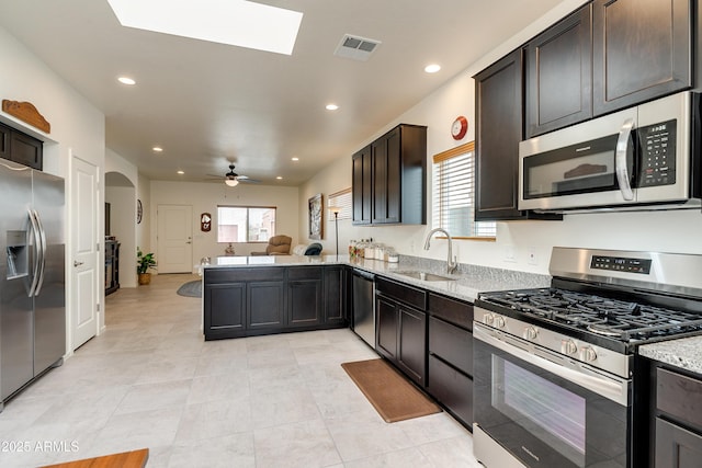 293 S Meadowood Ln, Sierra Vista, AZ 85635 - kitchen featuring stainless steel appliances, a sink, open floor plan, a peninsula, and light stone counters