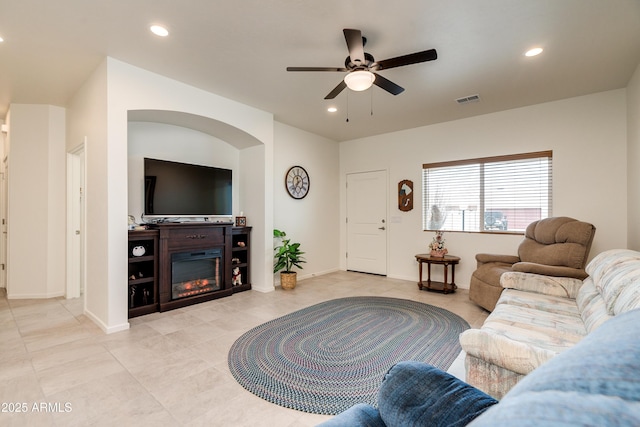 293 S Meadowood Ln, Sierra Vista, AZ 85635 - living area featuring ceiling fan, light tile patterned floors, recessed lighting, a glass covered fireplace, and baseboards