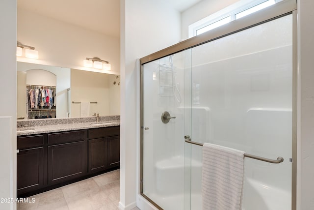 293 S Meadowood Ln, Sierra Vista, AZ 85635 - full bathroom featuring a stall shower, a spacious closet, and double vanity