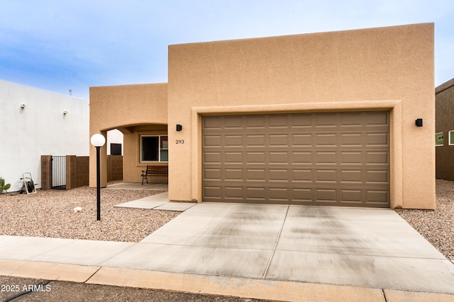 293 S Meadowood Ln, Sierra Vista, AZ 85635 - pueblo-style home featuring stucco siding, driveway, and a garage
