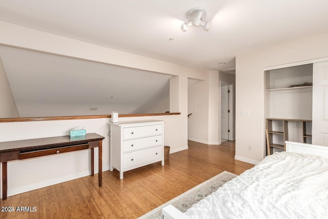 bedroom with light hardwood / wood-style floors and a closet