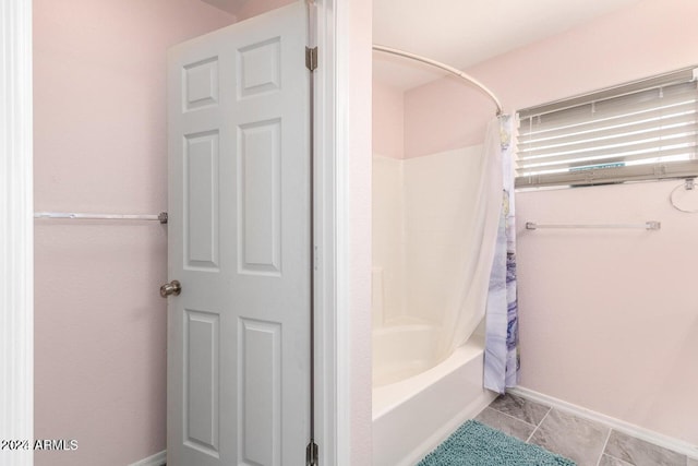 bathroom featuring tile patterned floors and shower / bath combo with shower curtain