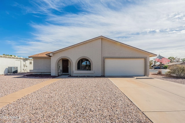 single story home with a garage and cooling unit